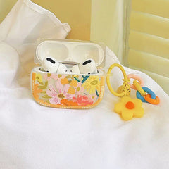 Gelbe AirPods-Hülle mit blühenden Blumen
