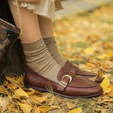 Mocasines con estampado de cocodrilo y hebilla de metal